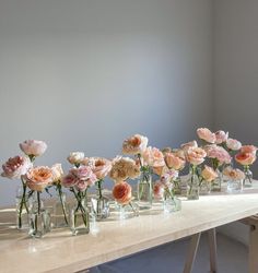 several vases filled with pink flowers on a table