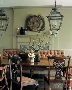 a dining room table with chairs and a bench in front of a fire place oven