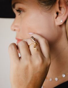 Intertwine yourself in luxury with our Snake Ring. The delicate snake design is expertly crafted with 14k gold plating and rhodium plating, exuding elegance and craftsmanship. Make a statement with this unique and timeless piece that alludes to the exotic and alluring world of the snake. Made in Colombia Luxury 14k Gold Snake-shaped Ring, Luxury Snake-shaped Wedding Ring, Luxury Snake-shaped Jewelry For Anniversary, Elegant Silver Snake Ring, Elegant Snake-shaped Rings For Anniversary, Elegant 14k Gold Snake-shaped Ring, Luxury Snake-shaped Wedding Jewelry, Formal Snake-shaped Jewelry, Luxury Yellow Gold Snake Shaped Ring