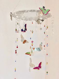 a mobile with butterflies hanging from it's sides