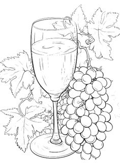 a glass of wine next to grapes and leaves