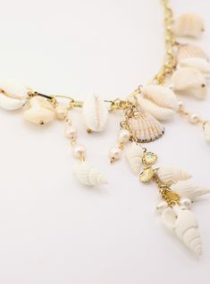 Jewel of the Sea – Lalinde Design Elegant Beach Jewelry With Pearl Pendant, Elegant Beaded Shell Pendant Necklace, Elegant Pearl White Jewelry For Beach, White Shell Jewelry With Ocean-inspired Style, Vacation Pearl Charm Strand Necklace, White Shell Necklace With Pearl Charm For Vacation, Pearl Necklace For Beach, Vacation Strand Necklace With Pearl Charm, Elegant Pearl Shell Necklace For Beach