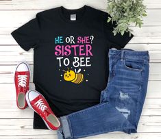 "Gender Reveal shirt with the quote \"He Or She Sister To Bee\" is a fun gift for men and women!  To see more designs of your topic Gender Reveal you can search & find them in my store:   https://www.etsy.com/shop/Retailorie  You find there also an announcement if the shipping & production times change :) * All Shirts Are Unisex * Product measurements may vary by up to 2 inches. * All Designs are originally made by myself or my team  gender reveal, party supplies, bee, her or she, baby, blue, boy or girl, pink, baby shower, gender reveal ideas, baby announcement, baby gender reveal, baby reveal party," Casual T-shirt With Letter Print For Gender Reveal, Baby Shower Gender Reveal Ideas, Custom Print T-shirt For Gender Reveal In Summer, Funny T-shirt For Gender Reveal With Letter Print, Casual T-shirt With Custom Print For Gender Reveal, Keeper Of The Gender Shirt Bee Theme, Cute Graphic Print T-shirt For Gender Reveal, Sister To Bee Shirt, White T-shirt With Name Print For Gender Reveal