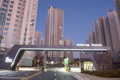 an empty street with tall buildings in the background