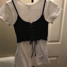 a white shirt with black lace up front