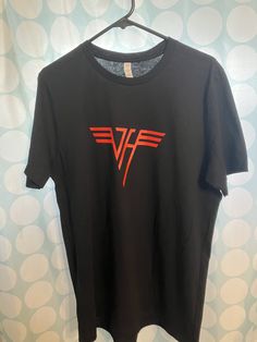 Van Halen Rock T-Shirt / Size is Large 100% cotton / Approx 27" from neck to bottom / 21" from pit to pit / 18" across the shoulders Vintage Van Halen logo from the days of classic rock Rock Style Cotton T-shirt With Logo Print, Rock Style Band Logo T-shirt With Crew Neck, Rock Style T-shirt With Logo For Concerts, Unisex Rocker Style Crew Neck T-shirt, Rock Style Logo Print Crew Neck Top, Red Band Logo T-shirt, Rock Style Crew Neck Top With Logo Print, Red Band Logo T-shirt Merch, Red Band Merch Top With Logo