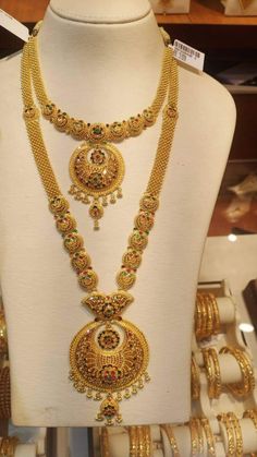 gold necklaces and bracelets on display in a store