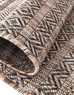 a close up view of a rug on the floor with an interesting pattern in it