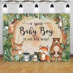 a baby boy is on his way sign with woodland animals and trees in the background