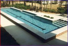 an empty swimming pool with steps leading up to it