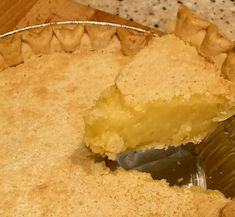 a piece of pie is being taken out of the pie pan with a spatula