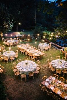 an image of a table and chairs set up in the yard with lights on them