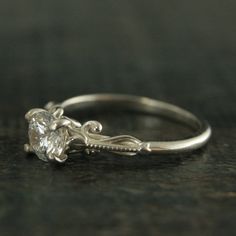 a white gold engagement ring with a single diamond