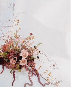 a bouquet of flowers on a white surface