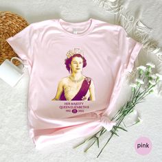 a pink t - shirt with the queen elizabeth on it