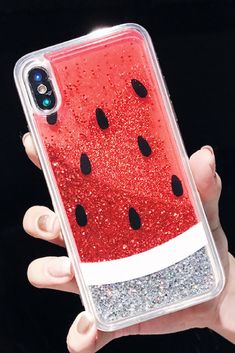 a watermelon phone case with glitter in the middle and black dots on it