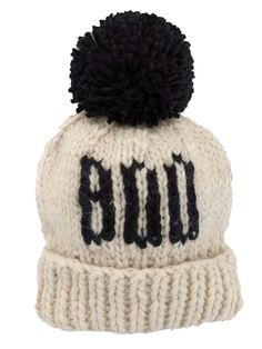 a white beanie with black pom - pom on top