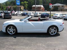 a white sports car parked in a parking lot