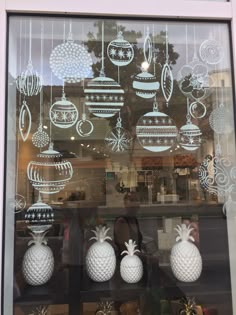 a window display with pineapples and ornaments in it