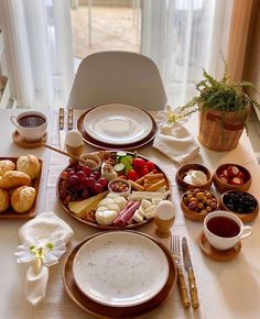 a table topped with plates and bowls filled with food