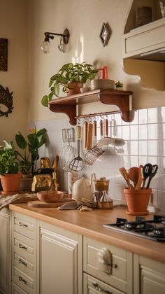 a kitchen counter with pots and utensils on top of it next to a stove