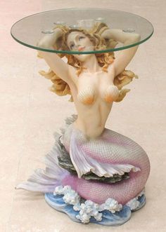 Glass topped mermaid table. Mermaid has blond hair and a pink tail, sitting on waves Mermaid Table, Mermaid Bar, Pastel Highlights, Mermaid Sculpture, Glass Top Side Table, Mermaid Statues, Gold Tray, Mermaid Glass, Cocktails Bar