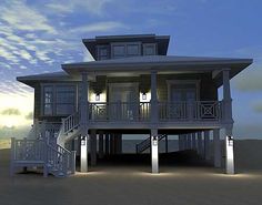 a three story house on the beach at night