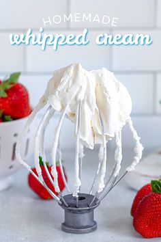 homemade whipped cream in a wire whisk with strawberries on the side and text overlay