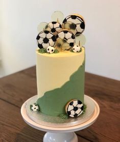 a cake with soccer balls on it sitting on a table