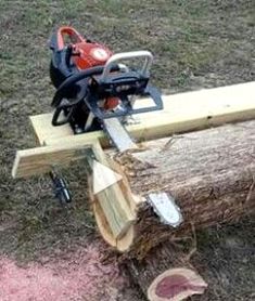 a chainsaw sitting on top of a wooden log