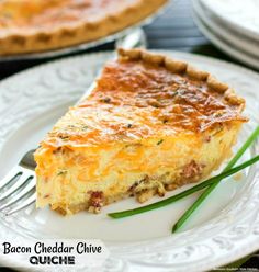 a slice of bacon cheesy quiche on a white plate with a fork