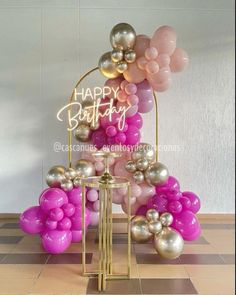 a birthday cake with balloons on it and a sign that says happy birthday over the top