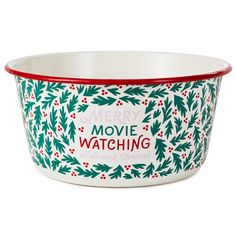 a merry movie watching bowl with holly and red trimmings on the bottom, sitting in front of a white background