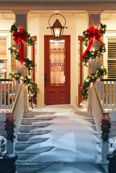 two wreaths on the front steps of a house decorated for christmas