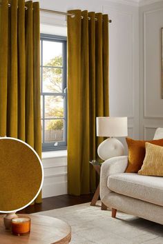 a living room with yellow curtains and a white couch in front of a large window