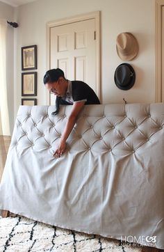 a man leaning on the back of a white couch