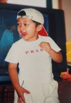 a young boy standing in front of a tv with his mouth open and tongue out