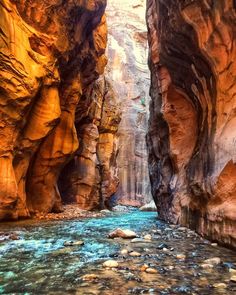 a narrow canyon with water running through it