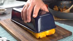 a person using a knife to cut up a piece of food on a cutting board