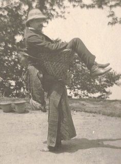 an old black and white photo of a man doing a trick