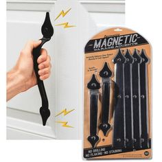 the magnetic door handle is black and has five magnets attached to it with one hand