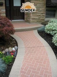 a brick walkway in front of a house