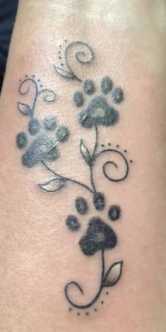 a black and white flower tattoo on the ankle