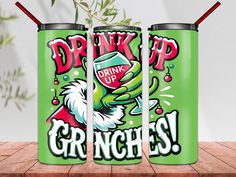 two green cans with the words drink up and gringies on them sitting on a wooden table