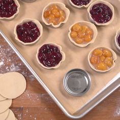 small pies are lined up on a cookie sheet and ready to go into the oven