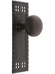 an iron door handle with a ball on the front and back of it, against a white background