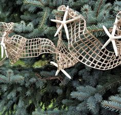 some ornaments are hanging from a tree in the shape of an airplane and a horse