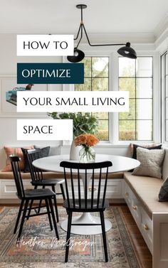 a small living space with white walls and black chairs, an area rug, and a round dining table