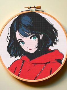 a cross - stitch picture of a woman with black hair wearing a red shirt and green eyes