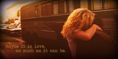 a woman is hugging her friend in front of a bus that says, maybe it is love as much as it can be